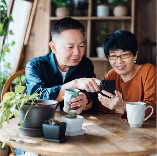Man and a woman looking at a phone
